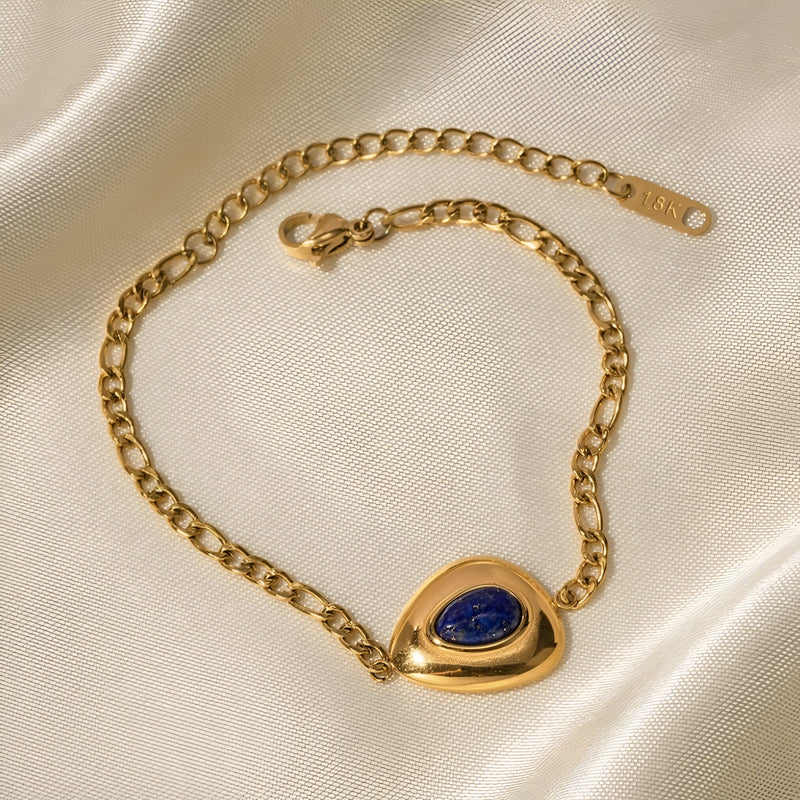 Bracelet doré en acier inoxydable avec pierre lapis lazuli ovale encastrée sur chaîne maille gourmette.