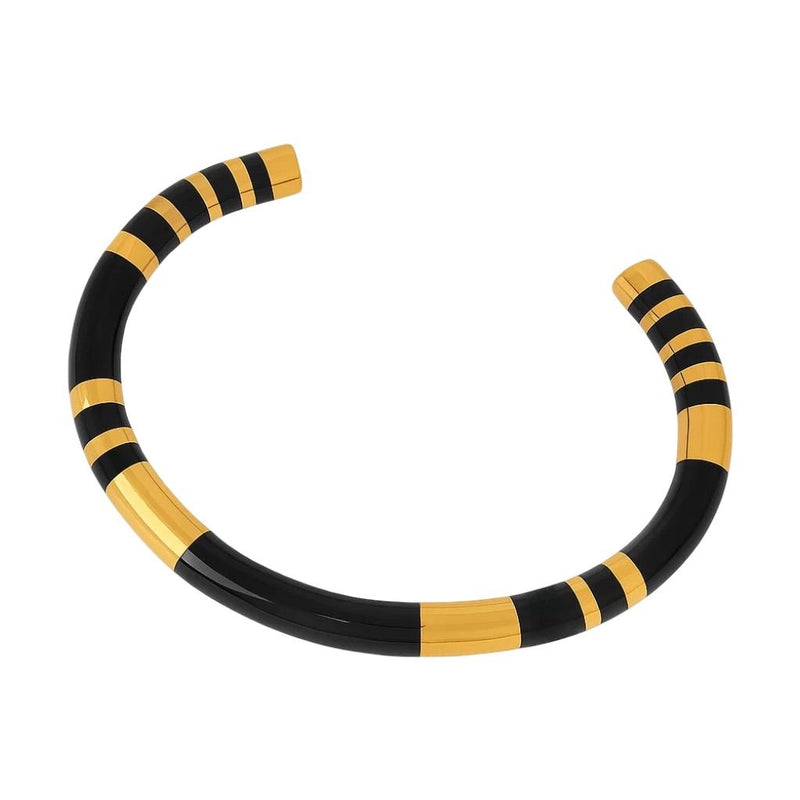 Bracelet jonc titane noir avec détails dorés rayés, style moderne et épuré.