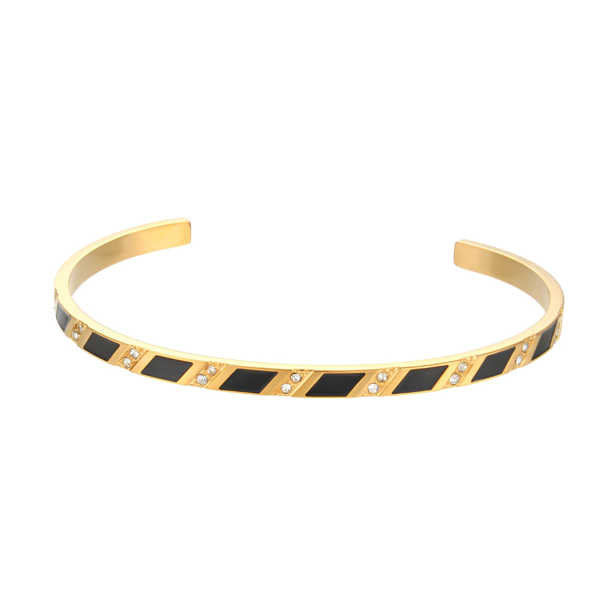 Bracelet jonc doré openwork avec motifs géométriques noirs et petits détails métalliques.