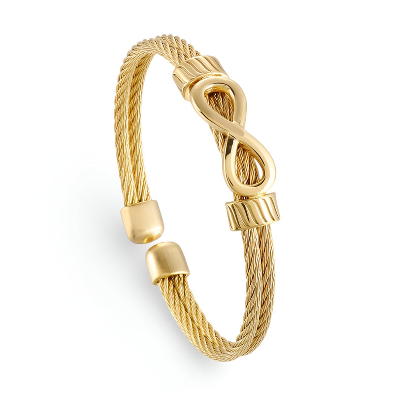 Bracelet jonc doré en acier inoxydable tressé avec motif infini central lisse.