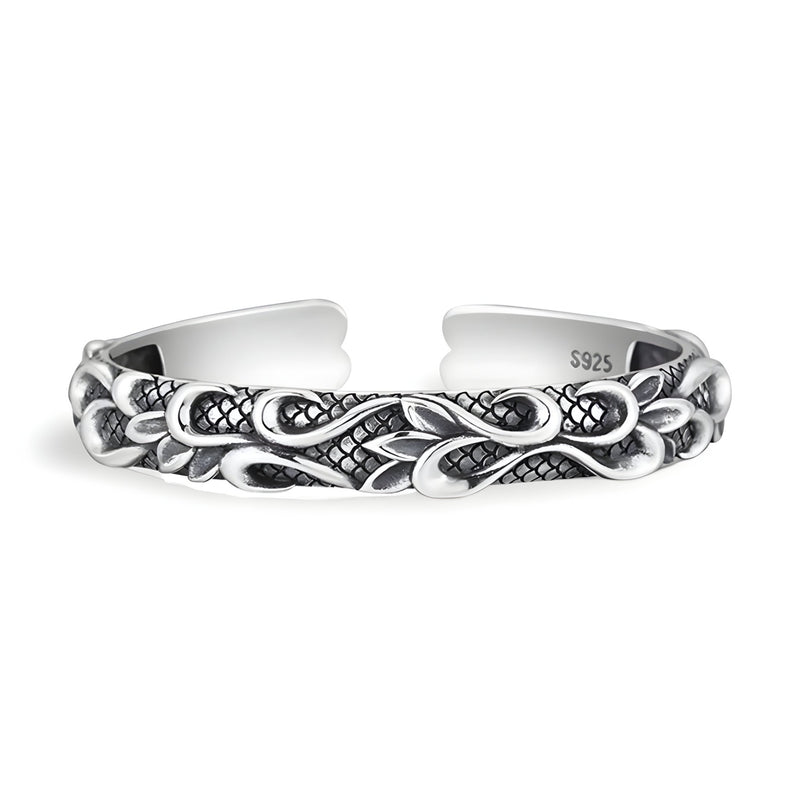 Bracelet jonc en cuivre plaqué argent avec motif vague et détails texturés, style masculin.