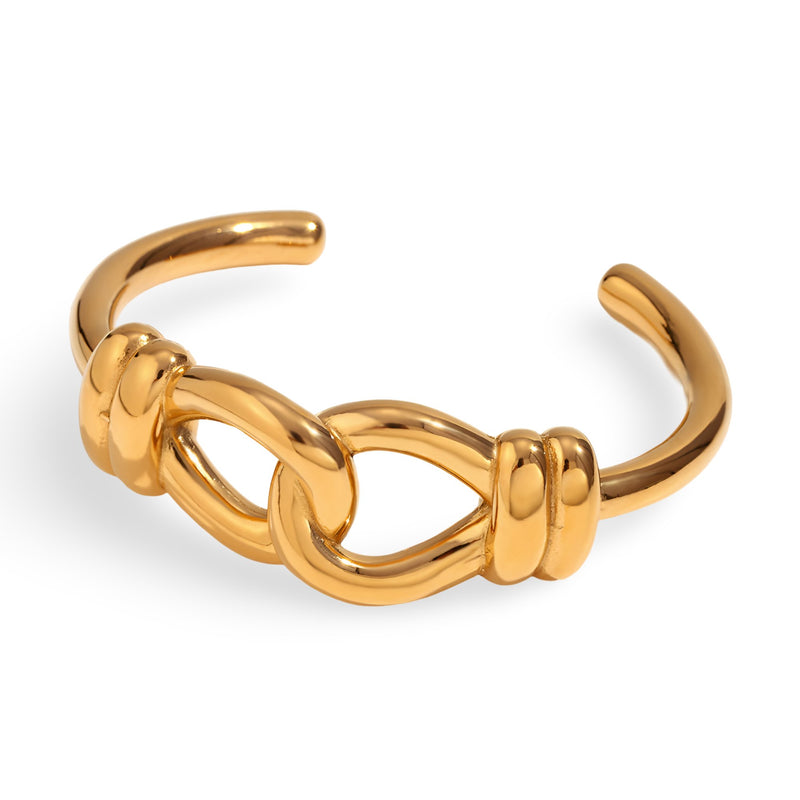 Bracelet jonc doré en acier inoxydable avec design de nœud d'agui élégant et lisse.