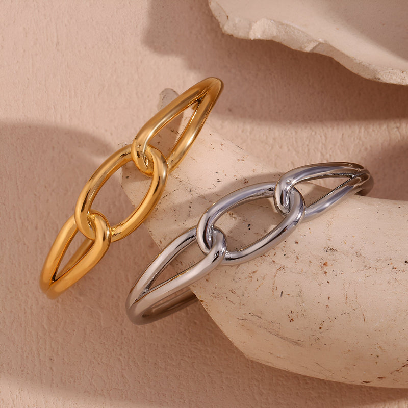 Bracelet jonc en acier inoxydable, maillon central large, finition or et argent, design moderne et épuré.