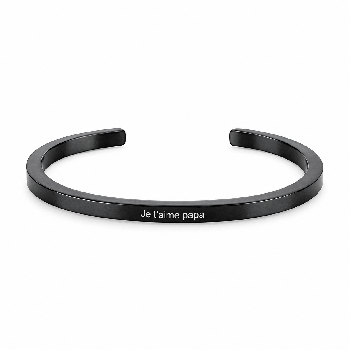 Bracelet jonc Vicky noir, gravure personnalisée Je t’aime papa, posé de face sur fond blanc