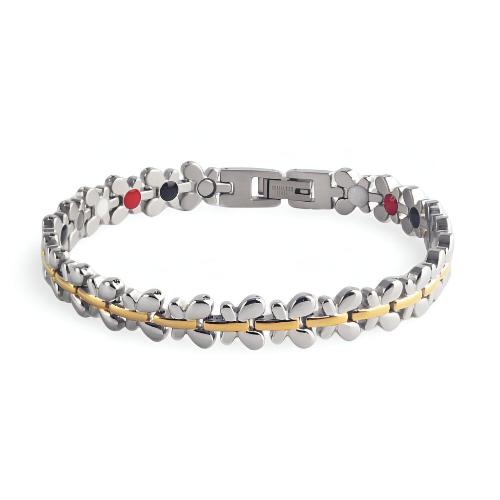 Bracelet magnétique Idunn en acier inoxydable argenté avec fine ligne dorée et pastilles rouges et noires.