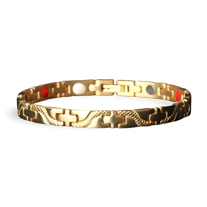 Bracelet magnétique fin en titane doré avec motifs gravés, intérieur à pastilles rouges et blanches.