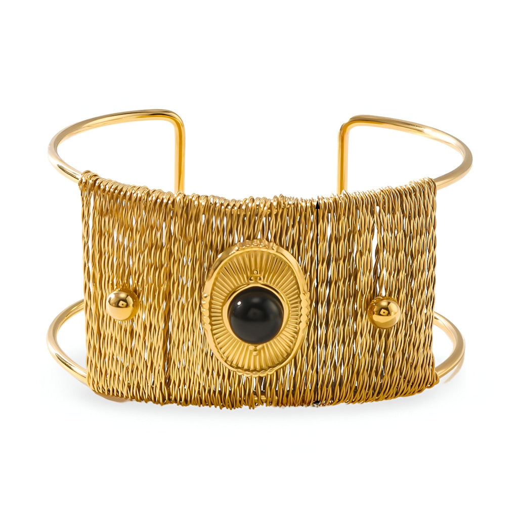 Bracelet manchette doré tissé avec pierre noire centrale et détails ronds brillants.