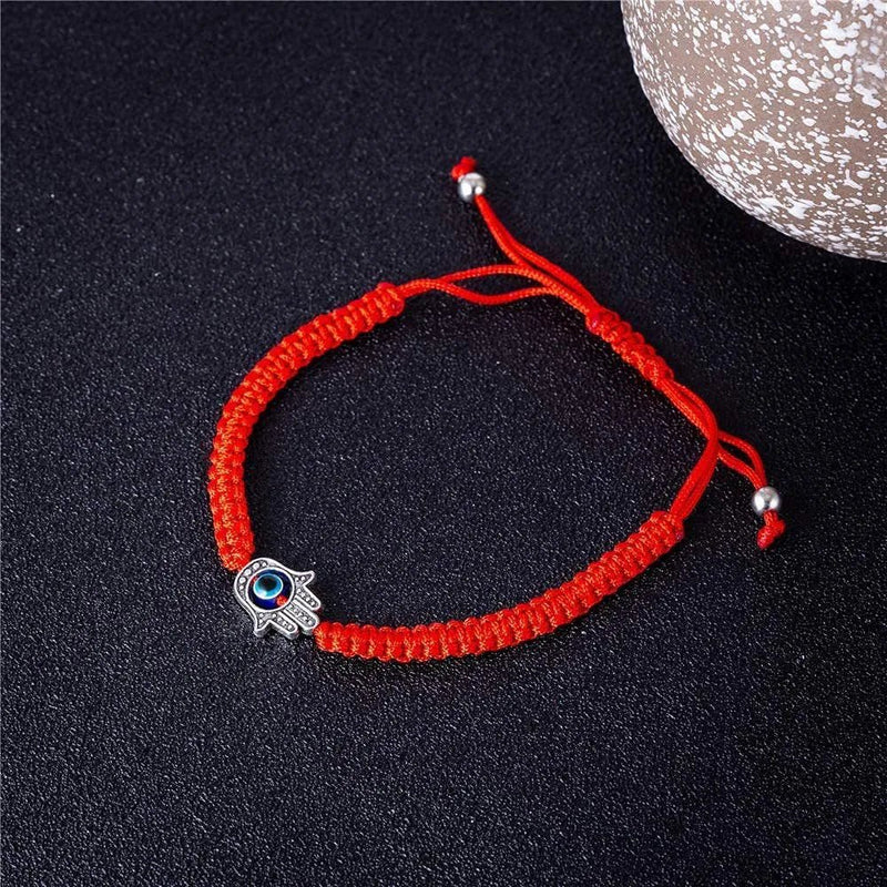 Bracelet rouge en fil ciré avec pendentif main de Fatma et œil bleu porte-bonheur.