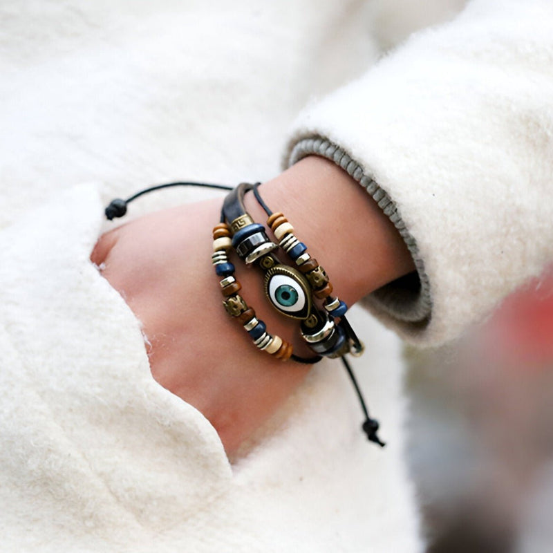 Bracelet multi-rangs en cuir marron avec œil de protection bleu et perles décoratives pour homme.