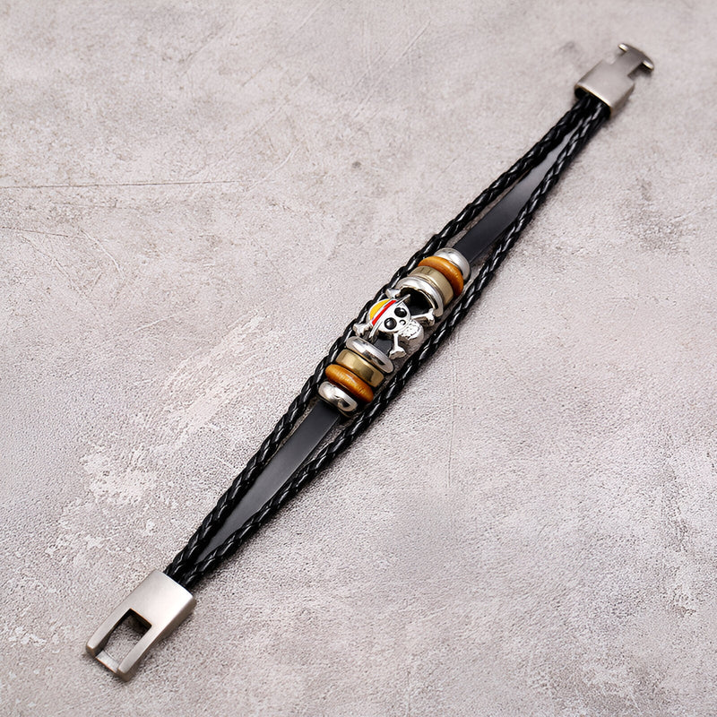 Bracelet multi-rangs en cuir noir avec motif tête de mort colorée et fermoir métallique argenté.