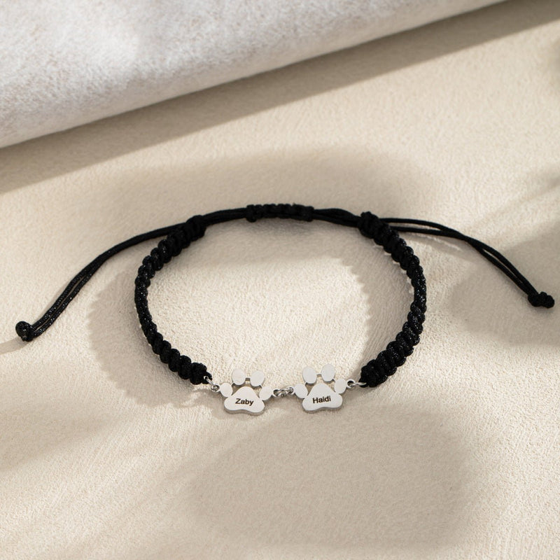 Bracelet noir en nylon avec deux breloques pattes en acier inoxydable argenté, ajustable, mixte.