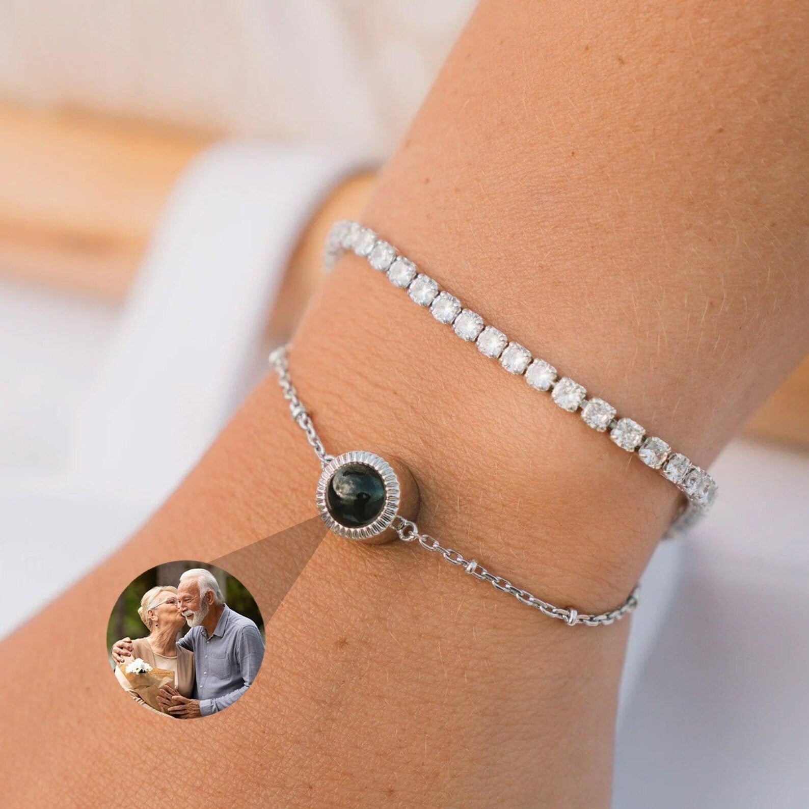 Bracelet double chaîne en argent avec zircon et médaillon photo personnalisable rond, porté au poignet.
