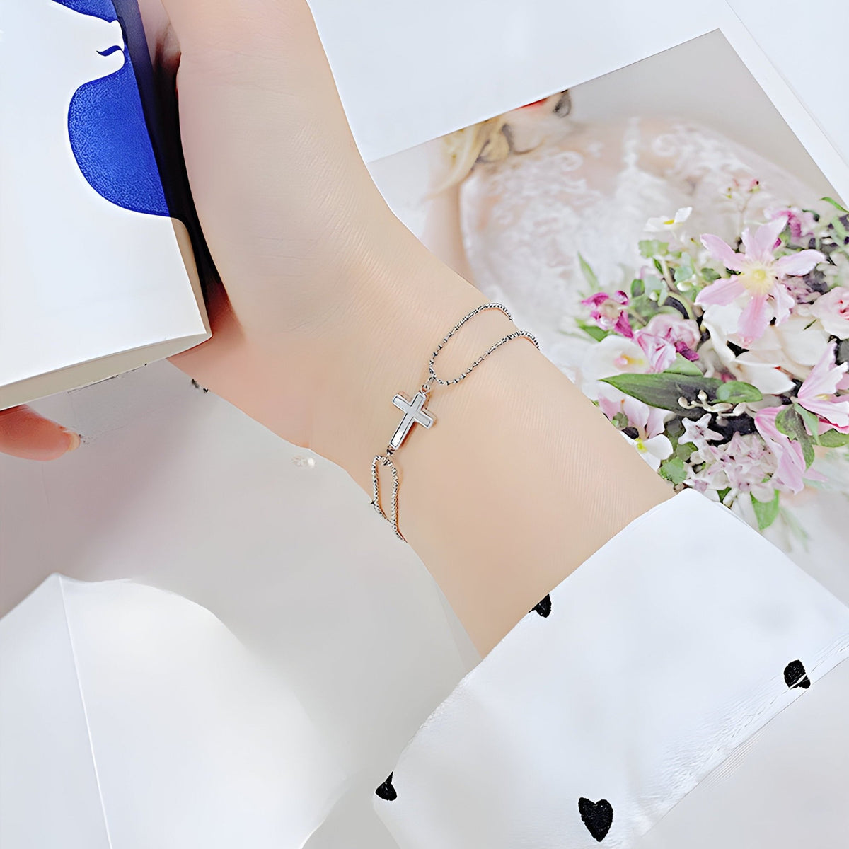 Bracelet femme en acier inoxydable argenté avec charm croix délicate et chaîne fine.