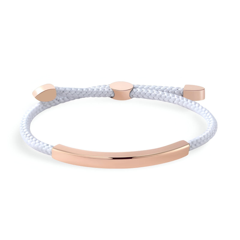 Bracelet femme cordon blanc avec détail barre et embouts en métal doré rose élégants.