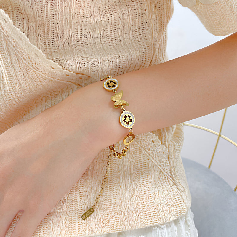 Pulsera para mujer de acero inoxidable, mariposa rodeada de flores, modelo Ganna
