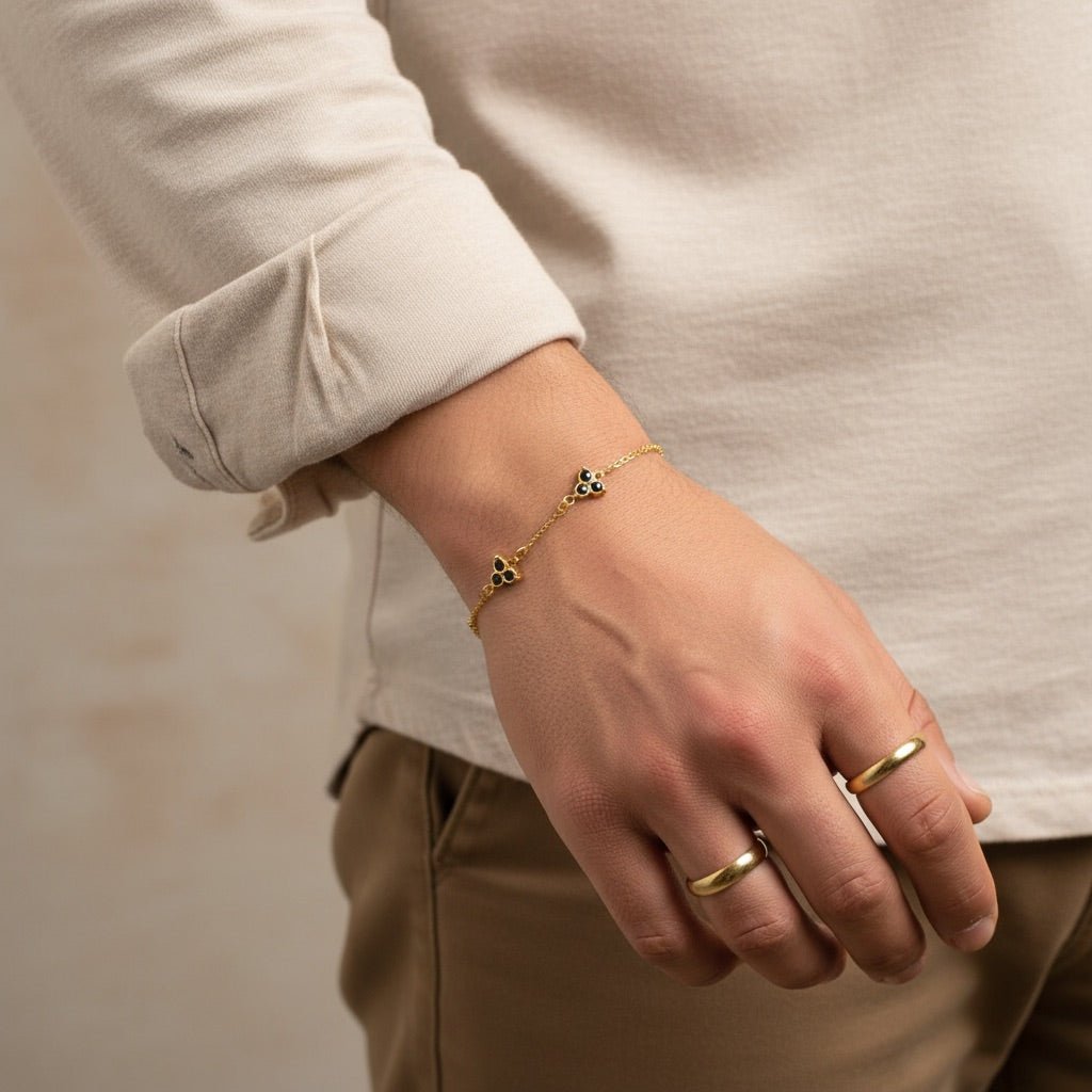Bracelet en chaîne fine dorée avec pendentif trèfle à 3 feuilles noir et doré, style chic homme.
