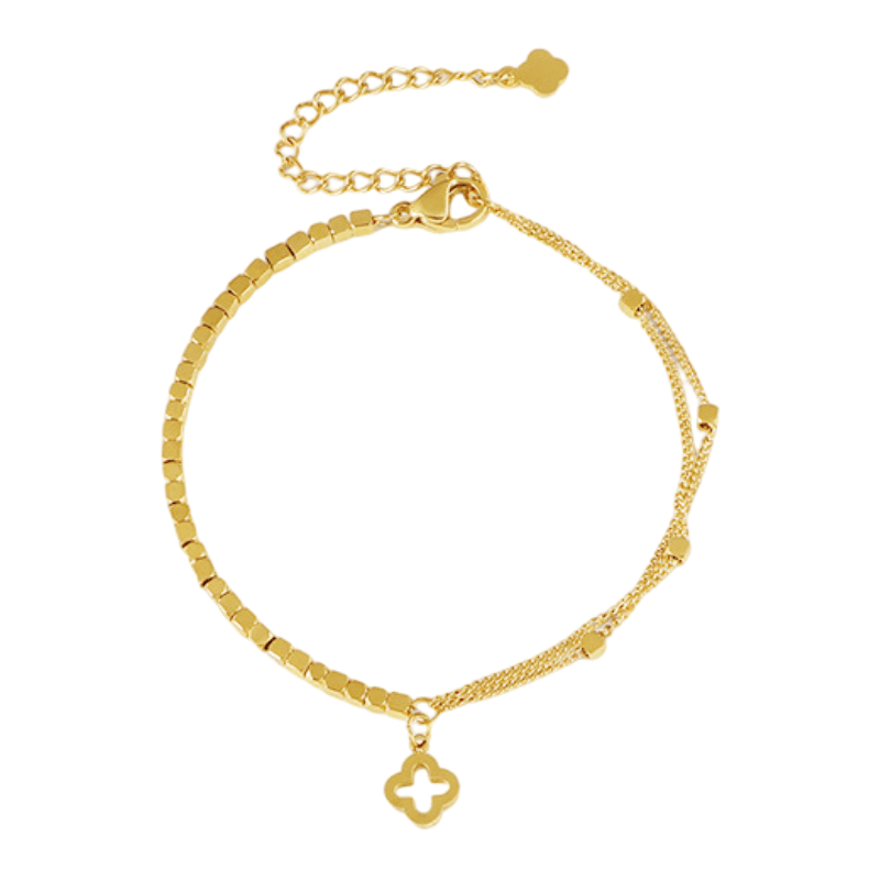 Bracelet doré en titane à deux chaînes fines avec pendentif trèfle porte-bonheur élégant.