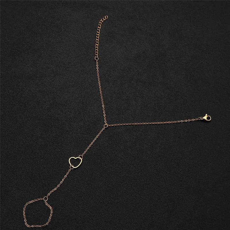 Bracelet chaîne de doigt en acier inoxydable or avec cœur central ajouré délicat.