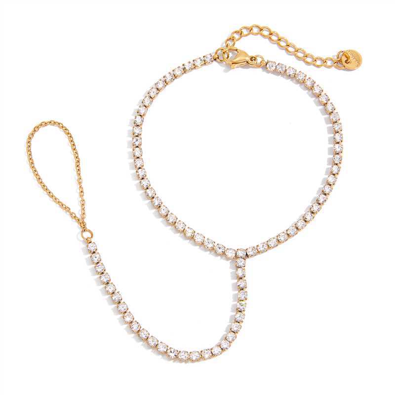 Chaîne de main dorée à l’or fin ornée de zircon blanc scintillant, style élégant et délicat.