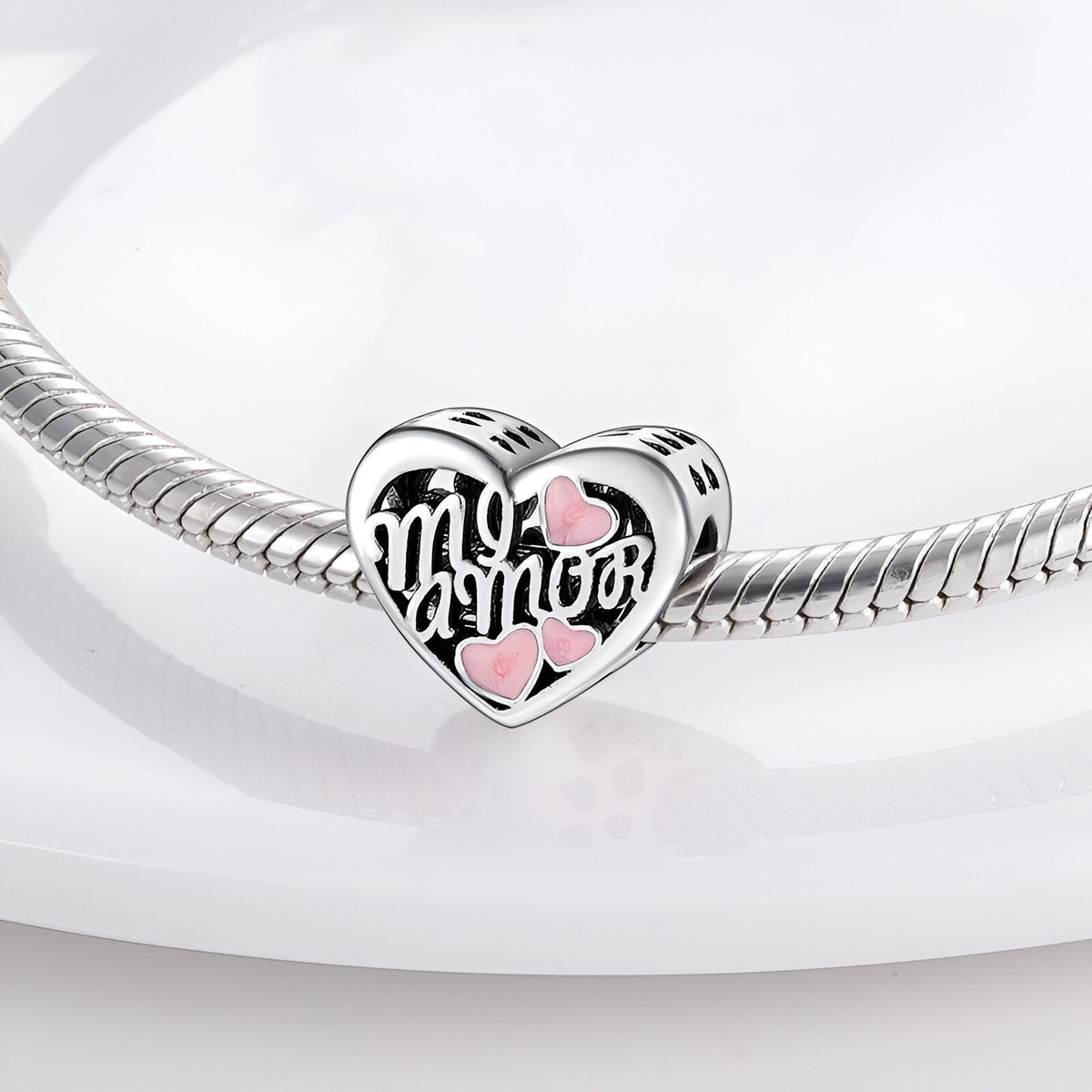 Charm en forme de cœur en argent avec inscription « mi amor » et deux petits cœurs roses, monté sur bracelet serpent argenté.
