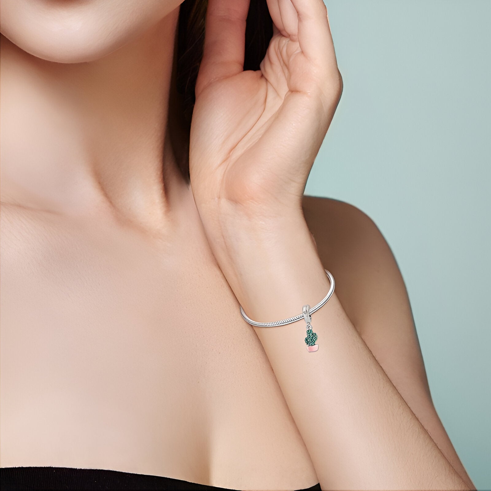 Bracelet argent fin avec pendentif cactus vert orné de strass scintillants.