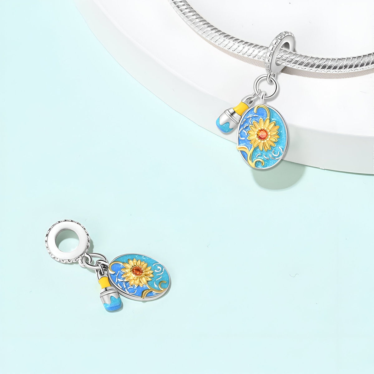 Charm pendentif ovale argenté avec tournesol jaune et petit pendentif bouteille bleue sur chaîne serpent.