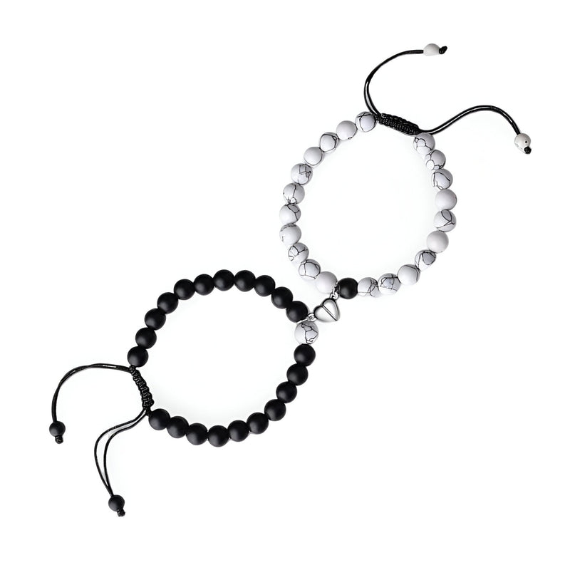 Duo de bracelets en pierres naturelles noire et blanche avec cœur aimanté en métal, cordon ajustable noir.