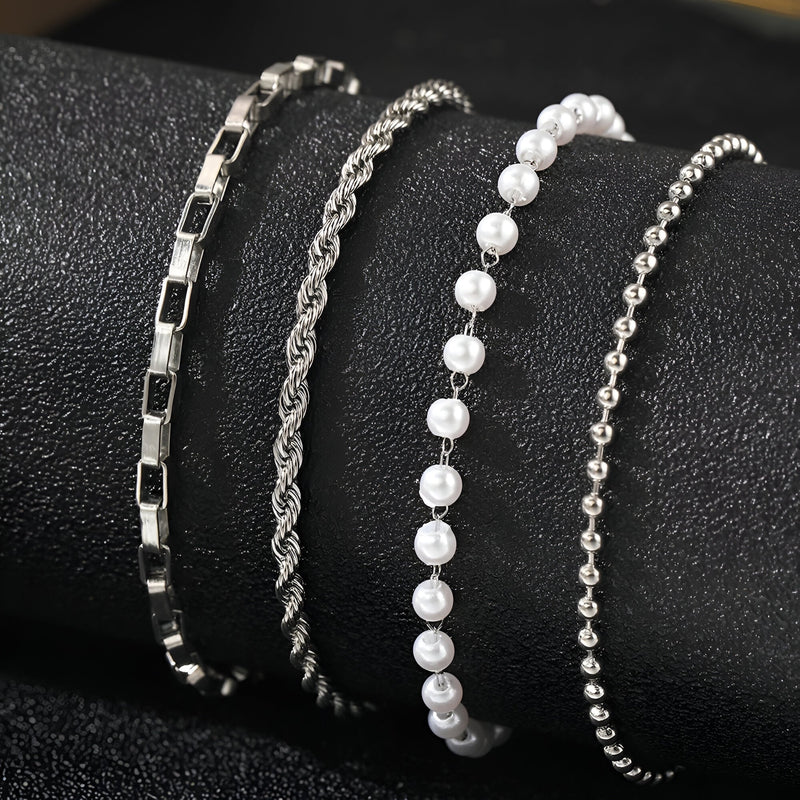 Ensemble de 4 bracelets en acier inoxydable argenté, designs variés incluant perles et chaînes texturées.