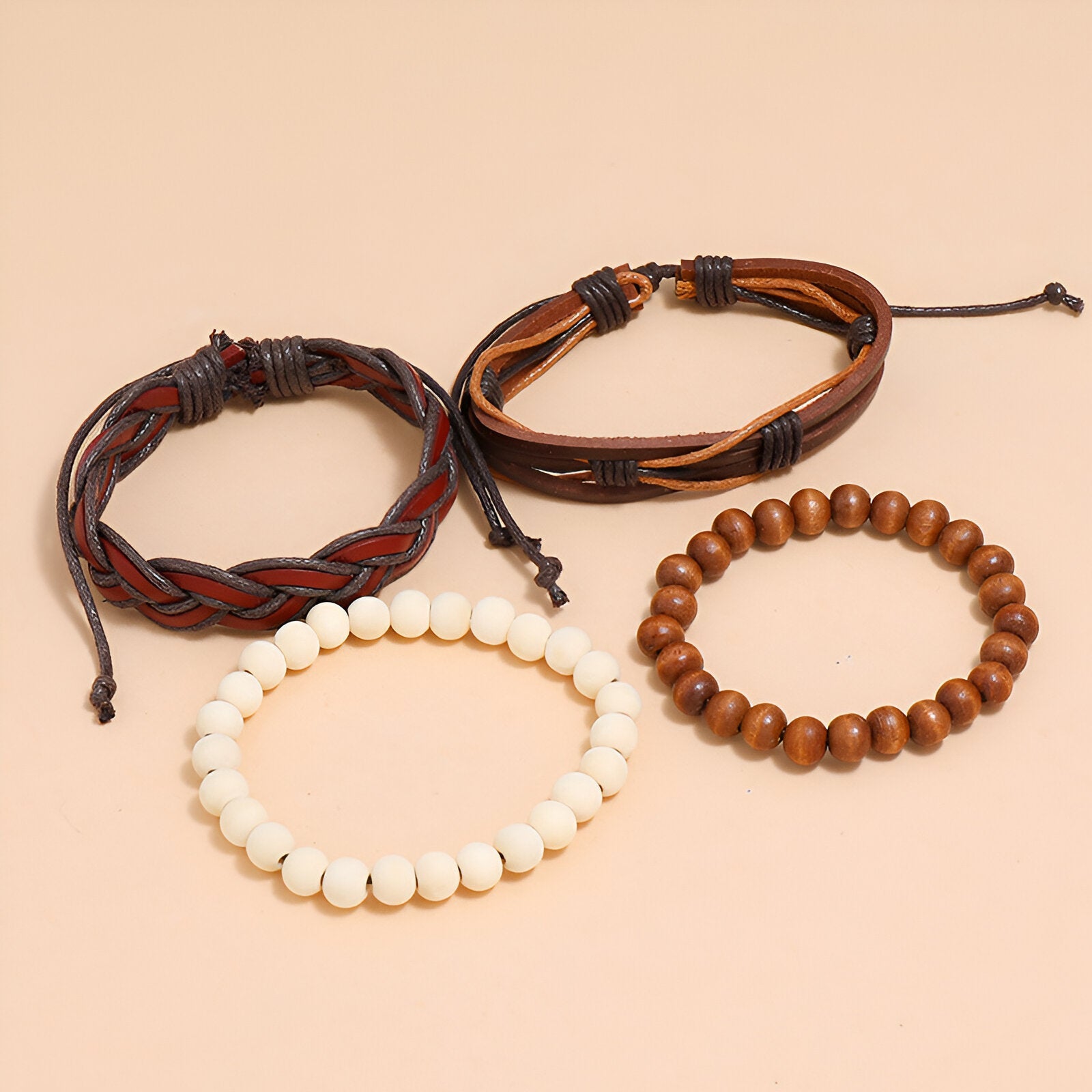 Deux en cuir tressé, un en perles blanches, un en perles bois rondes.