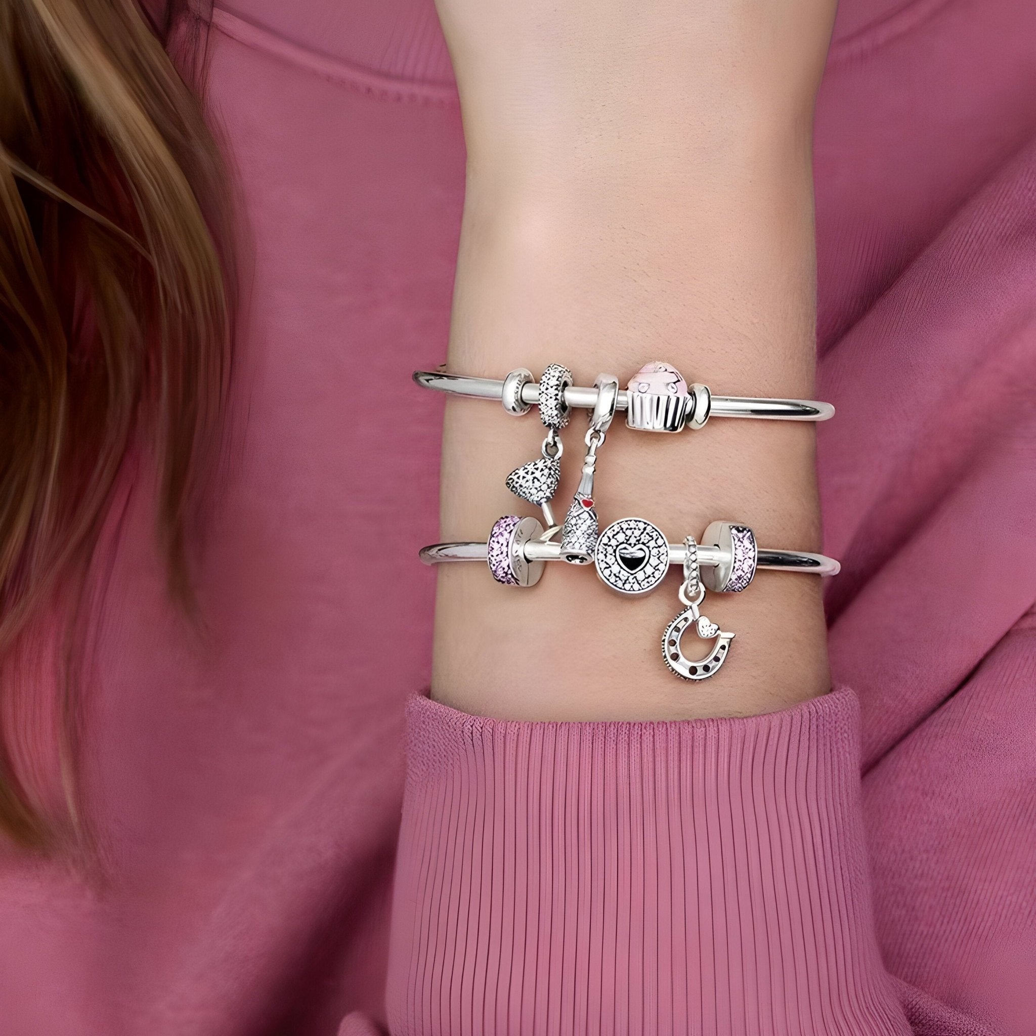 Bracelets argentés fins avec espaceurs et breloques éclatantes sur poignet féminin.