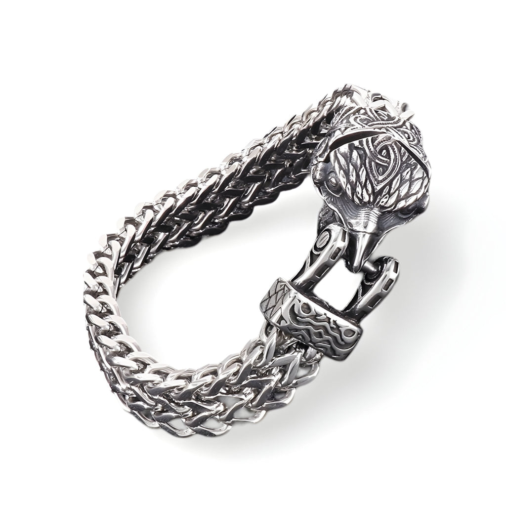 Bracelet en acier inoxydable argenté avec fermoir tête d'aigle détaillé et maillons tressés doubles.