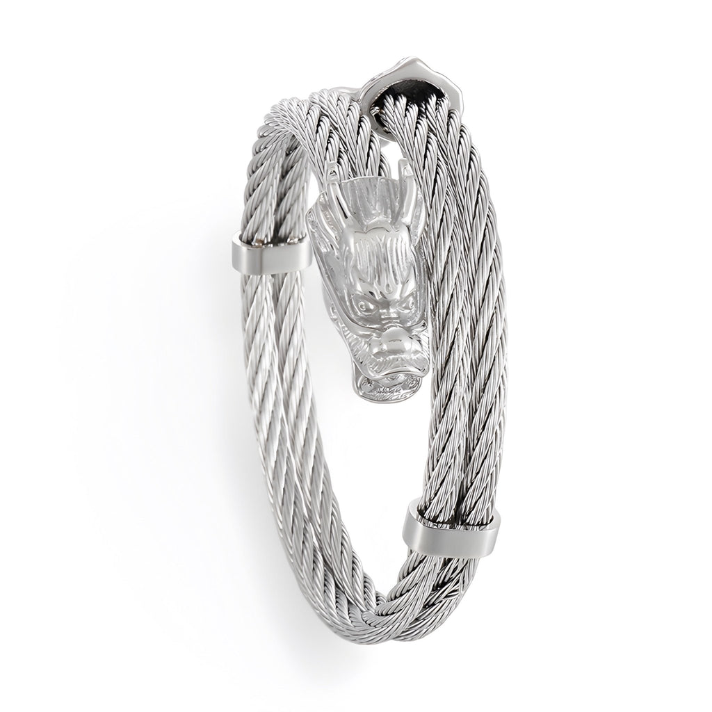 Bracelet jonc homme en acier inoxydable argenté avec tête de dragon sculptée et câble tressé.