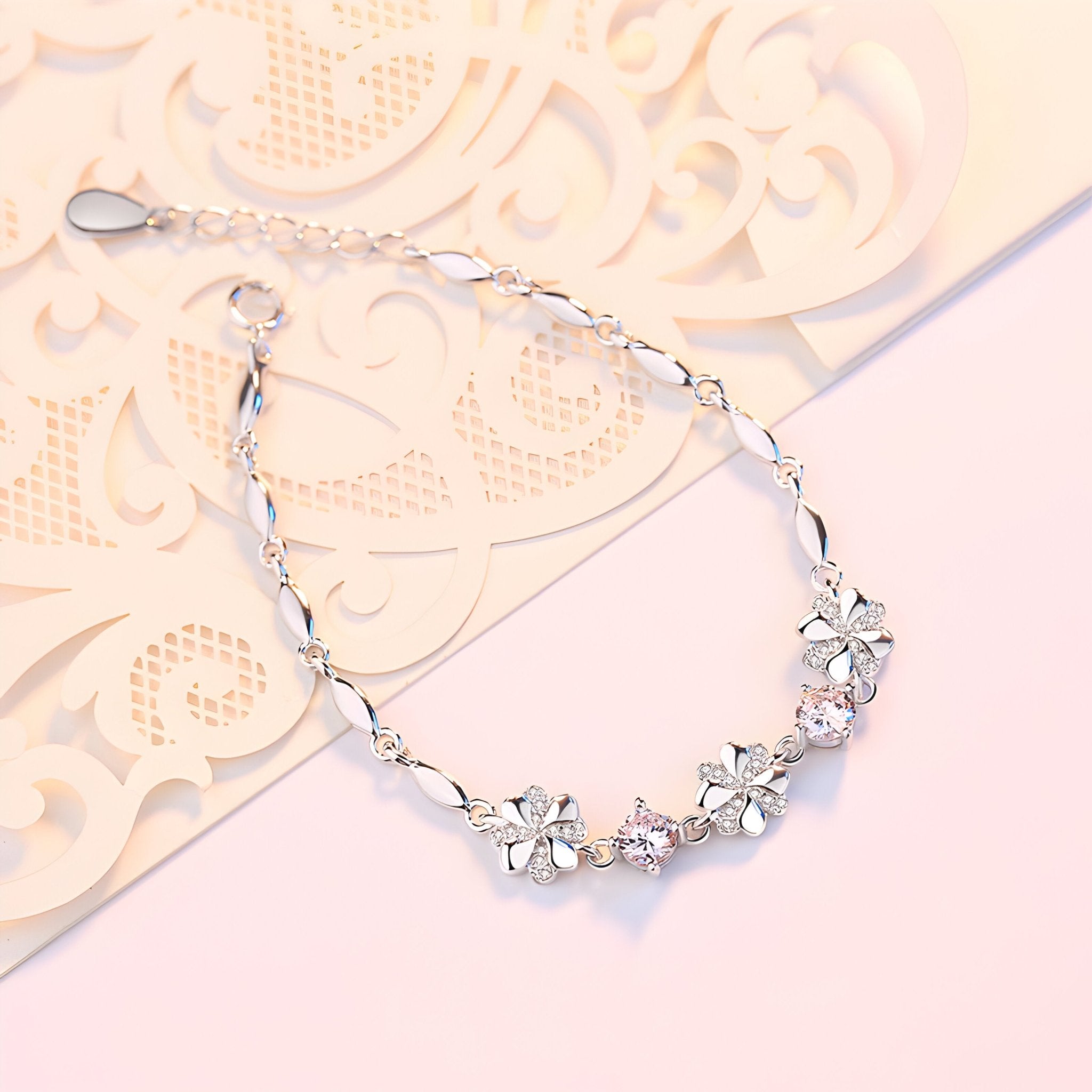 Bracelet en argent avec chaîne fine et pendentifs trèfles à quatre feuilles délicats.
