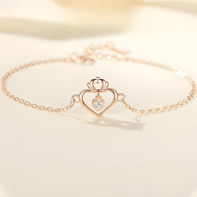 Bracelet en argent sterling or rose avec pendentif coeur ajouré et petit diamant central.