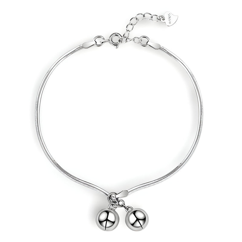 Bracelet fin en argent sterling avec deux perles suspendues et chaîne ajustable.