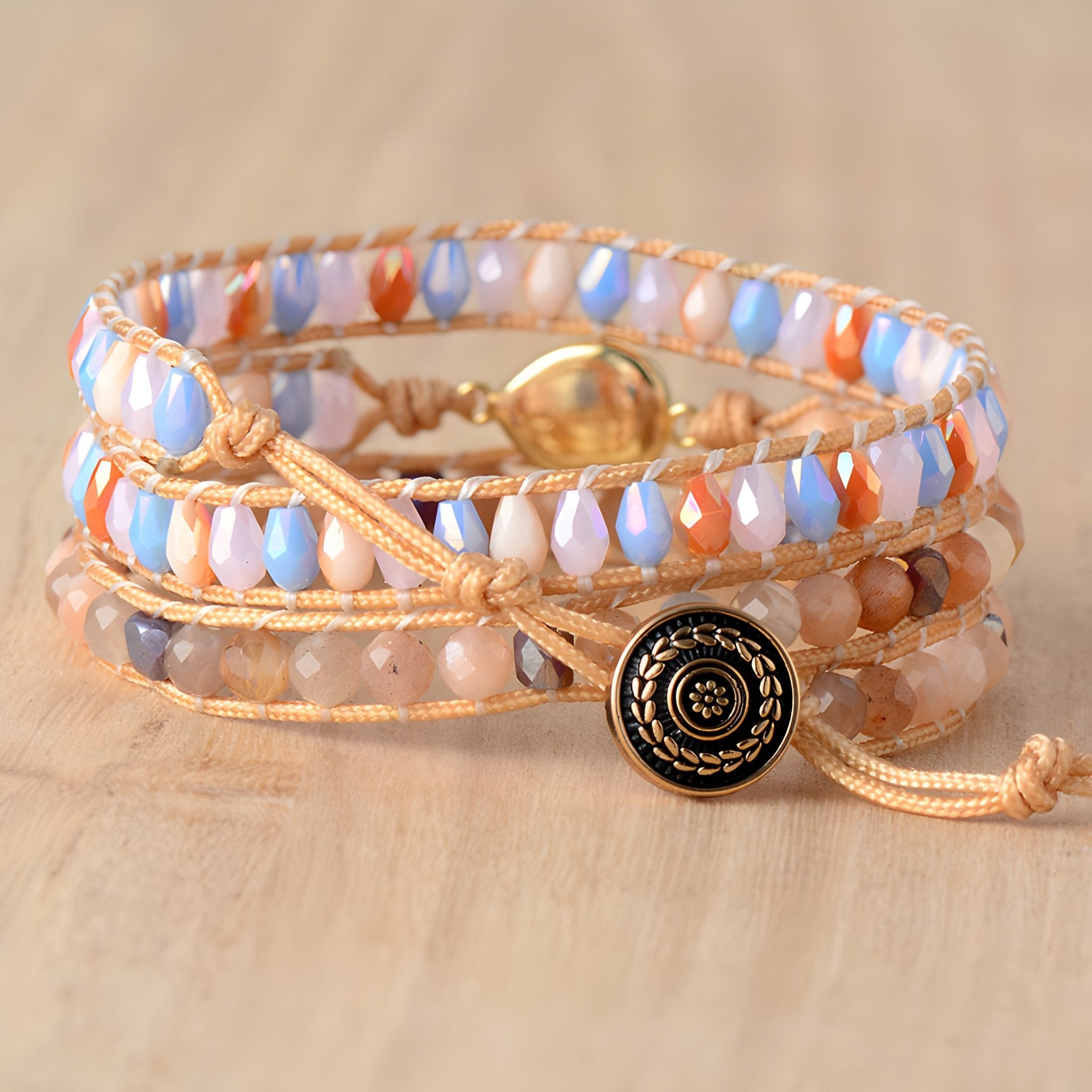 Bracelet multi-rangs en perles de cristal bleu, opale blanche, corail et beige avec lien en corde beige et bouton décoratif.