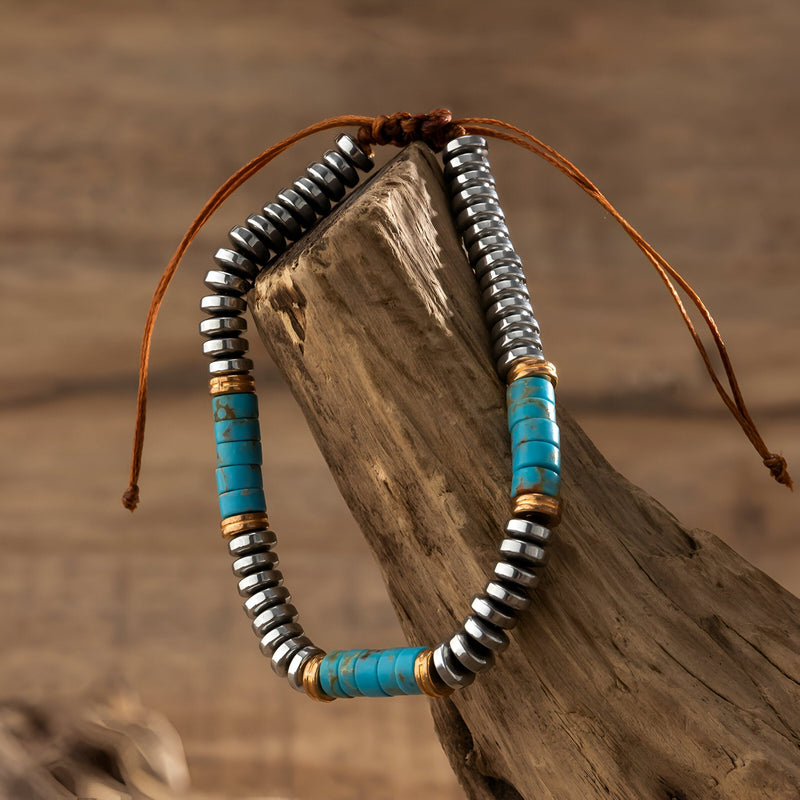 Bracelet homme en métal argenté avec perles turquoise et cordon marron ajustable.