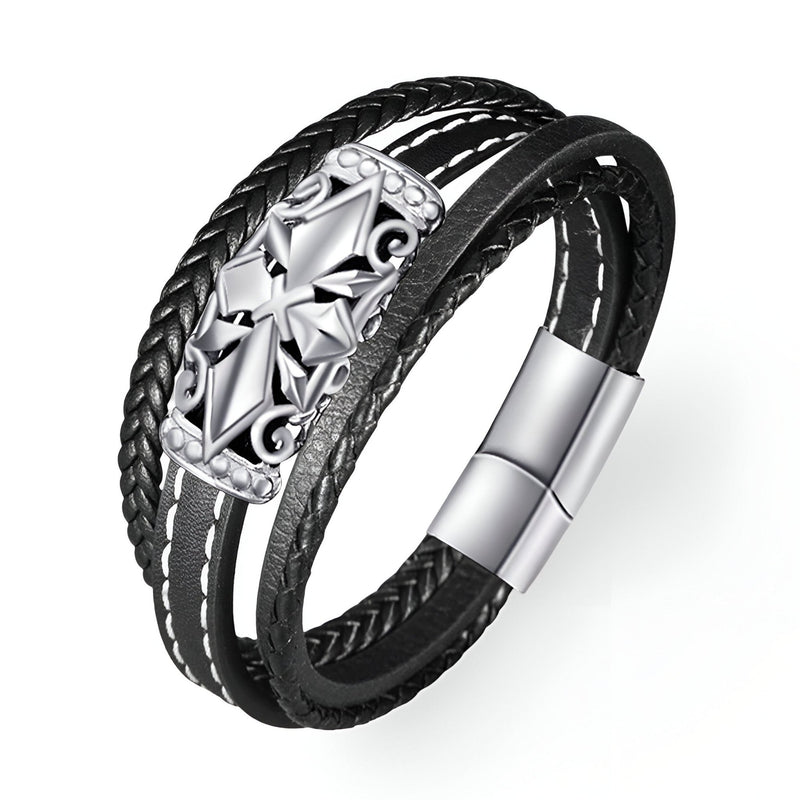 Bracelet multi-rangs noir avec croix détaillée en métal argenté et fermoir magnétique.