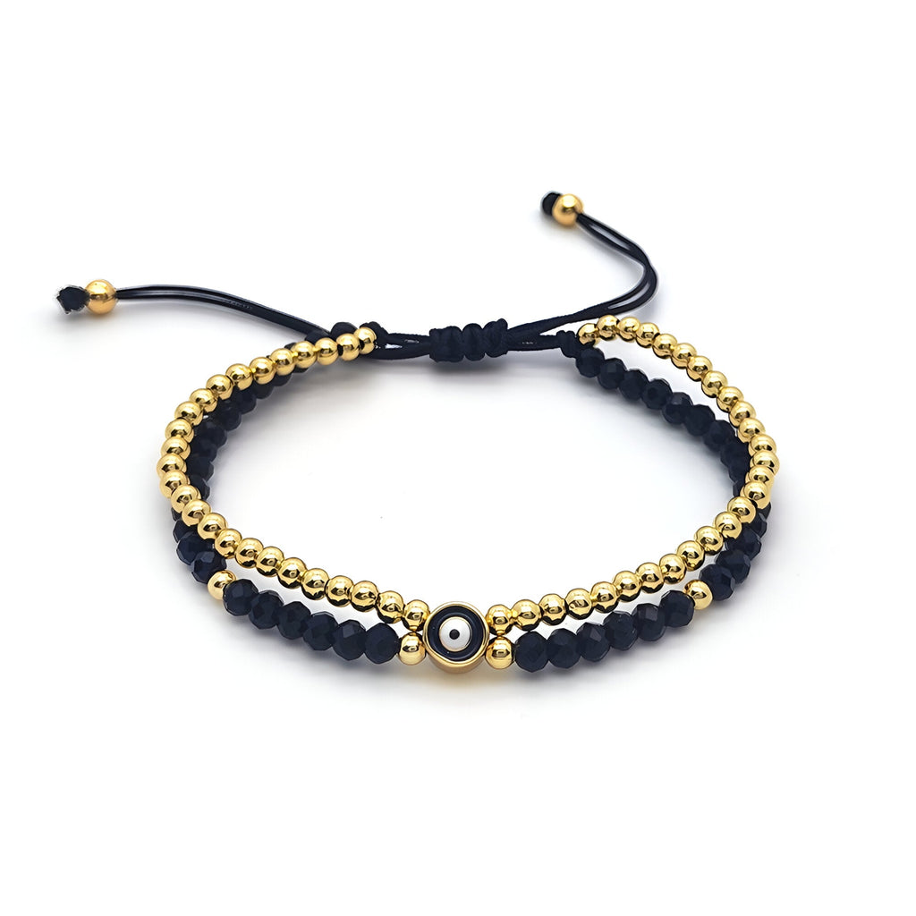 Trio de bracelets noirs et dorés à perles et strass avec fermoir coulissant noir.