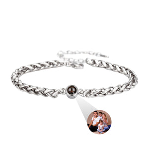 Bracelet en acier inoxydable maille tressée argentée avec perle centrale projetant une photo personnalisée familiale.