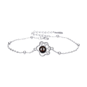 Bracelet fin en argent 925 plaqué or avec pendentif patte d’animal et photo projetée au centre, chaîne maille forçat.