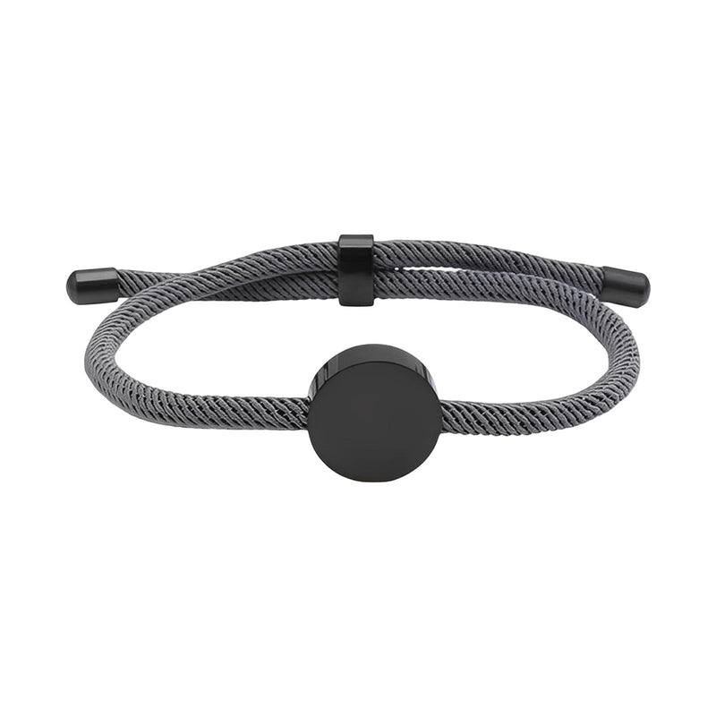 Bracelet cordon gris avec médaillon rond en acier inoxydable noir et fermoir ajustable.