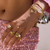 Bijou de main doré en acier inoxydable avec papillons, perles blanches, zircons et chaîne cubaine délicate.