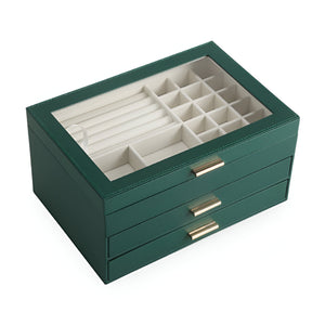 Boîte à bijoux nomade grande taille verte avec tiroirs multiples et compartiments variés sous couvercle transparent.