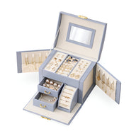 Boîte à bijoux nomade bleue avec miroir intégré, multiples compartiments et rangements bijoux interior crème.