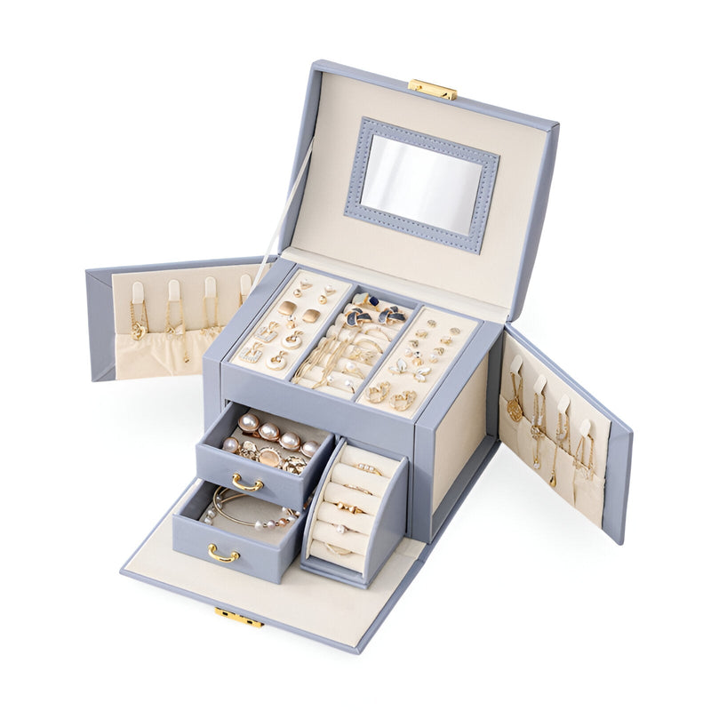 Boîte à bijoux nomade bleue avec miroir intégré, multiples compartiments et rangements bijoux interior crème.