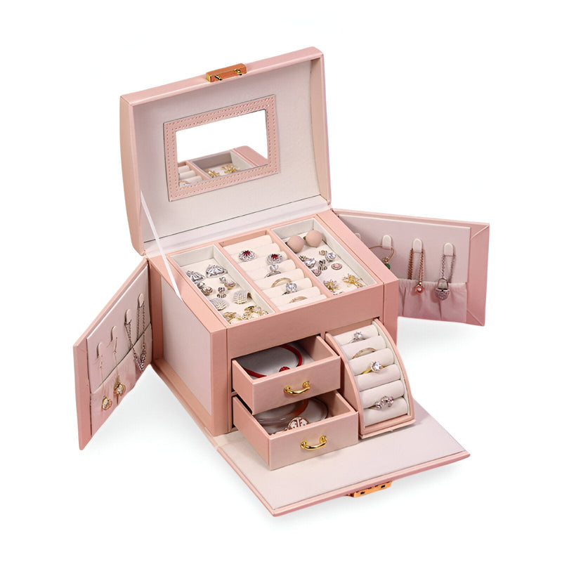Boîte à bijoux nomade rose avec miroir intégré, multiples compartiments et crochets pour colliers.