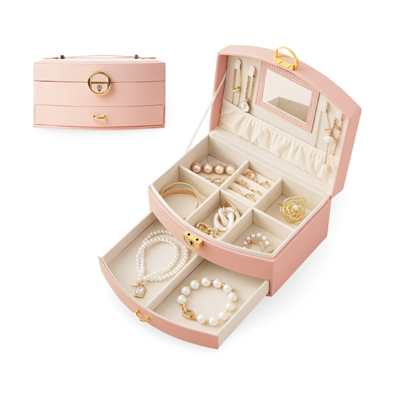 Boîte à bijoux nomade rose avec miroir intégré, compartiments multiples et fermeture dorée.