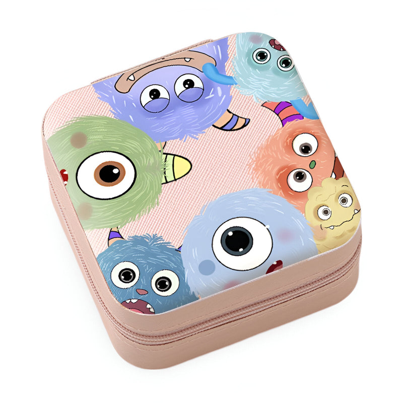 Boîte à bijoux rose nomade avec motif coloré de monstres aux grands yeux et formes rondes.