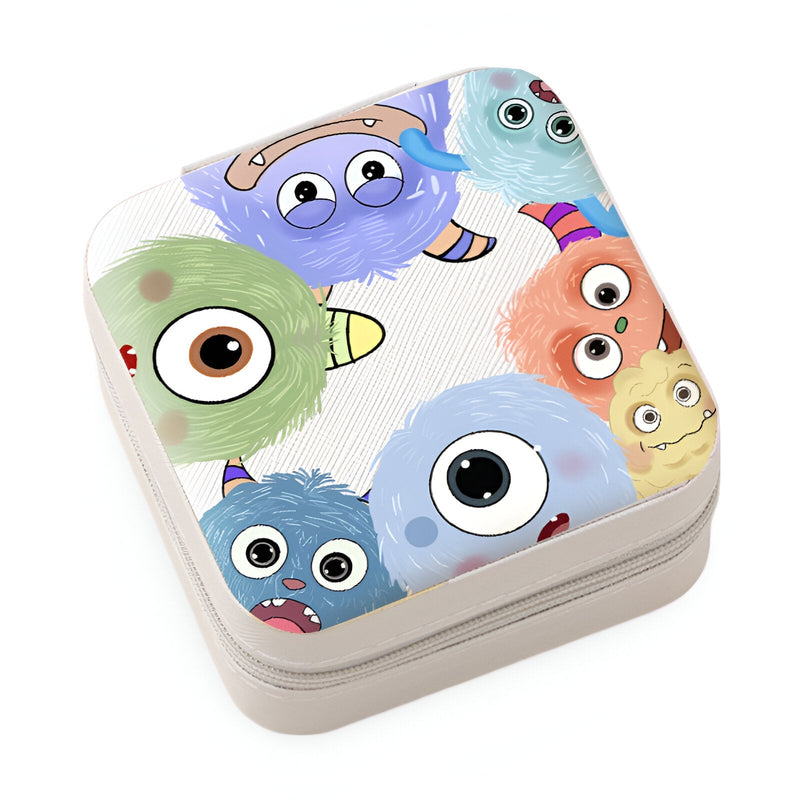 Boîte à bijoux blanche avec motif monstres colorés enfantins aux grands yeux et sourires amusants.